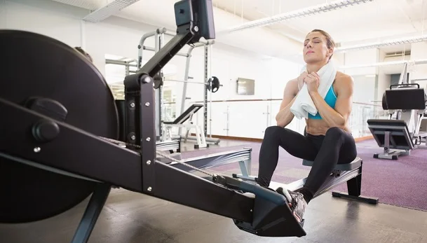 Tired young woman in gym