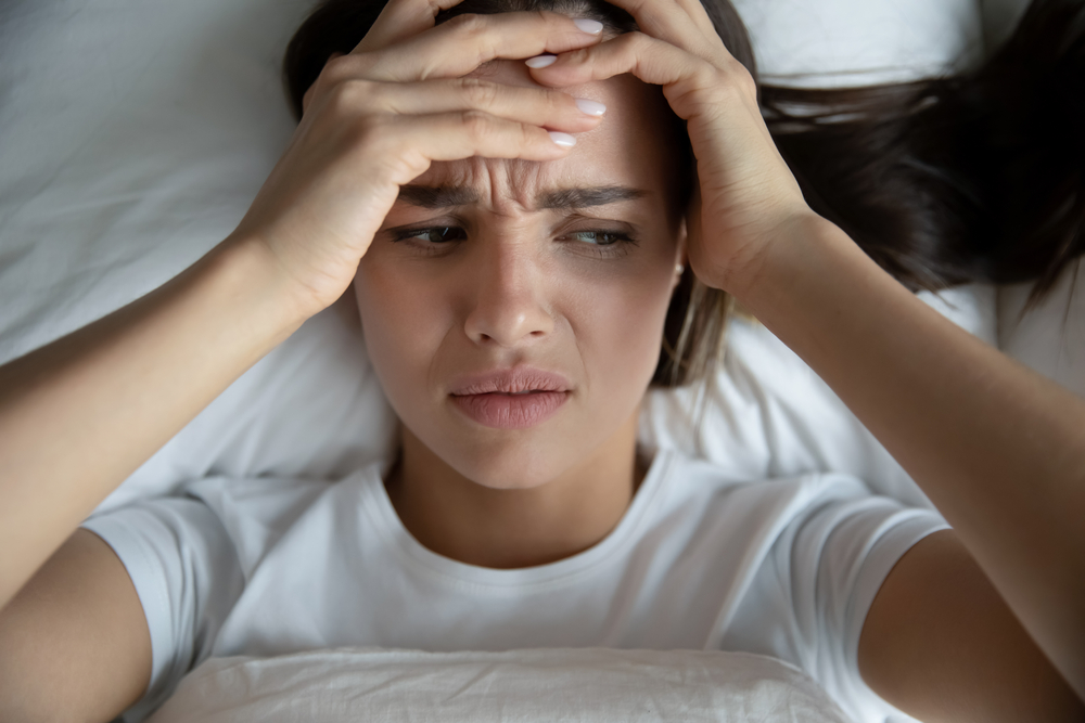 Woman in bed with fibromyalgia pain