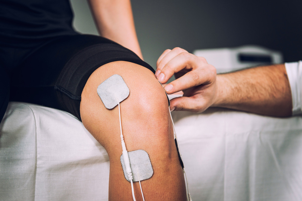 Patient Applying Electrical Stimulation Therapy on Knee Joint. T